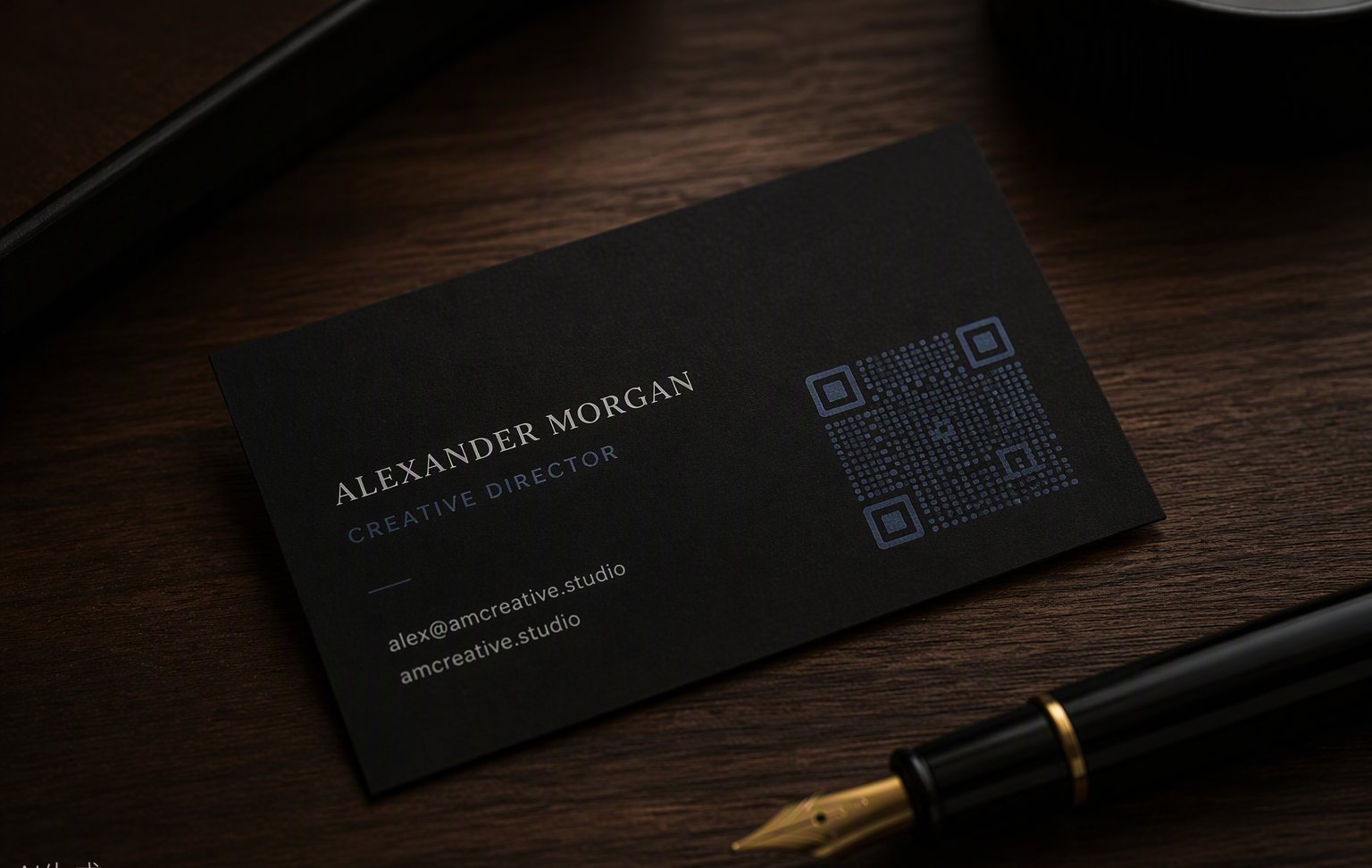 A matte black business card with a QR code beside a fountain pen